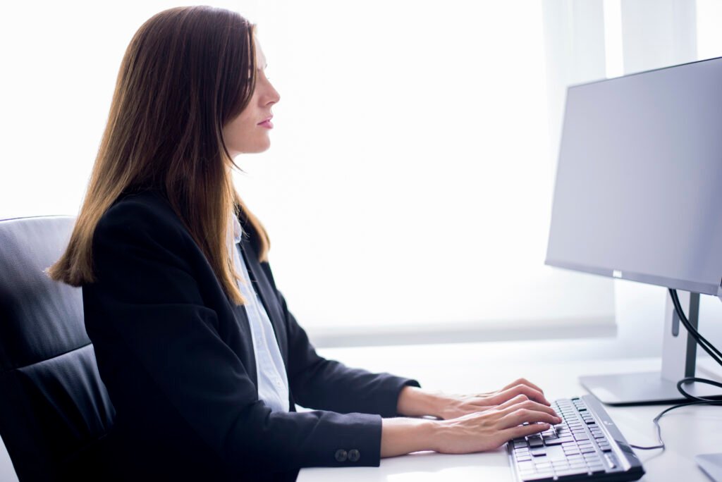 woman sitting typing computer